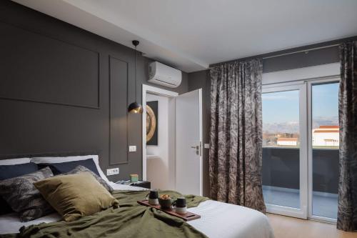 a bedroom with a bed and a large window at Villa with pool near sandy beach - by TRAVELER tourist agency Krk - ID 2224 in Privlaka