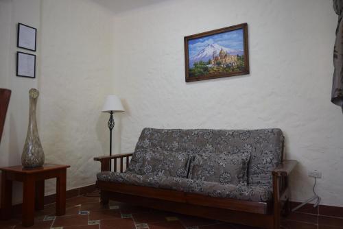 a living room with a couch and a picture on the wall at Hotel Casa el Moro in Puerto Morelos