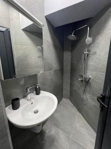 a bathroom with a sink and a shower at NJ Luxury Room in Varna City