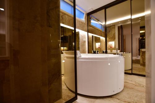 a bathroom with a white sink and a mirror at Domus De Cinti Boutique Rooms in Tivoli