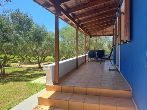 a porch with a wooden roof and chairs on it at Nikos Kastro 3 in Kástro Tornéze