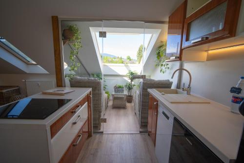 a kitchen with a sink and a window at Apartmány Revenite in Jeseník