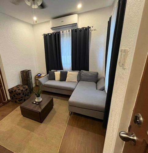 a living room with a couch and a table at House of Ellisse in Lipa