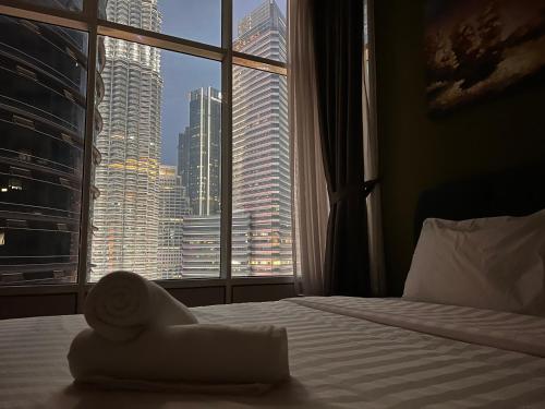 a hotel room with a view of a city from a window at Sky Suites at KLCC by Mitstay in Kuala Lumpur