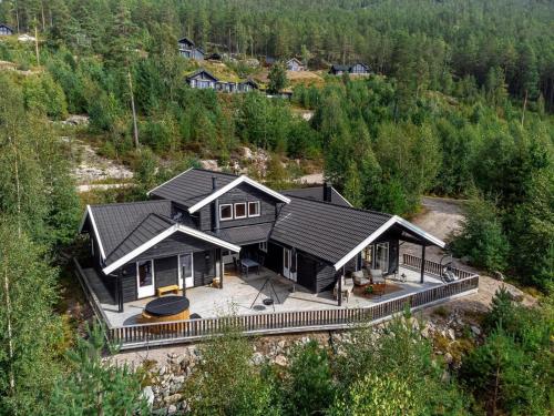 an aerial view of a house with a black roof at Verhøf Hytte - 9p - With Sauna & Hot Tub in Vradal