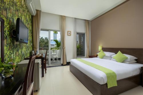 a bedroom with a bed and a desk and a television at Skyline Boutique Hotel in Phnom Penh