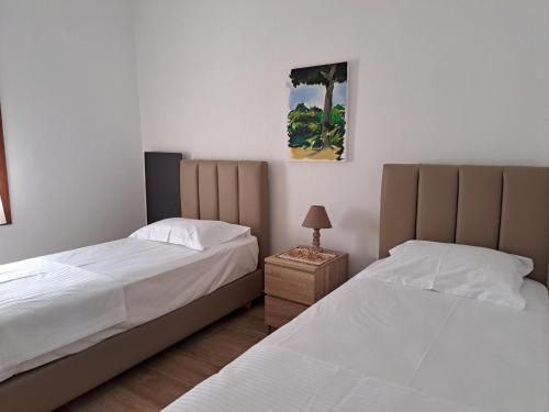 two beds sitting next to each other in a bedroom at Blue Fox 3 in Chrani