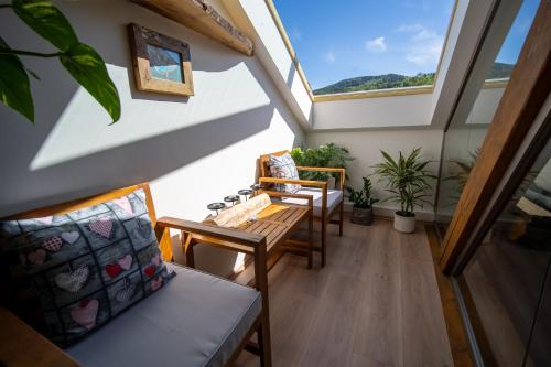 an attic room with skylights and a table and chairs at Apartmány Revenite in Jeseník