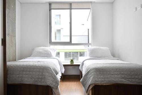 Ein Bett oder Betten in einem Zimmer der Unterkunft Ulivin Coliving