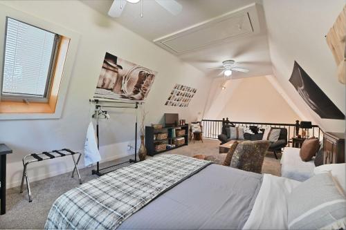 a bedroom with a bed and a living room at Hathaway Hideaway Loft Apartment in Hathaway Pines
