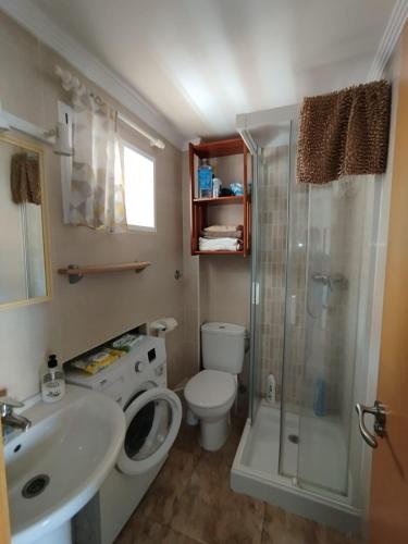 a bathroom with a toilet and a shower and a sink at Oasis Playa de Gandía in Gandía