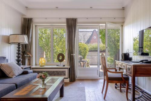 a living room with a couch and a table at Strönhof Kampen in Kampen