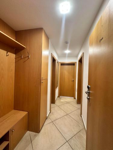 a hallway with wooden cabinets and a hallway with a door at Hotel Muza in Košice