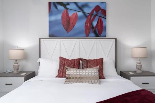 a bedroom with a large white bed with red pillows at Brand new Apt Oak Mt St Park Lots of Amenities in Pelham