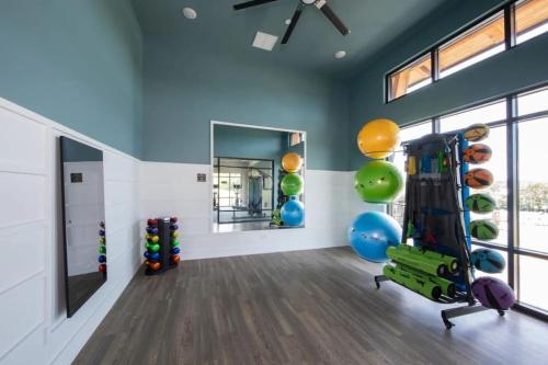 a gym with exercise equipment in a room with windows at Brand new Apt Oak Mt St Park Lots of Amenities in Pelham