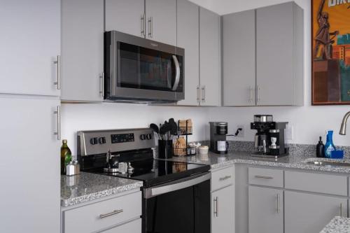 a kitchen with a stove and a microwave at Near Oak Mt Amphitheatre and Pelham Civic Complex in Pelham
