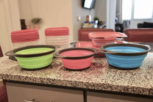 three colorful pots sitting on a counter with chairs at Near Oak Mt Amphitheatre and Pelham Civic Complex in Pelham