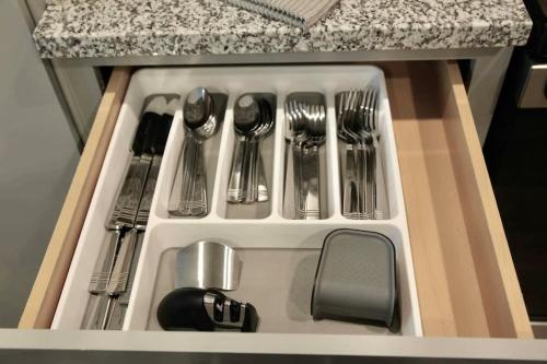 a drawer with silver utensils in a kitchen at NEW Apt Oak Mt St Park Great Amenities in Pelham