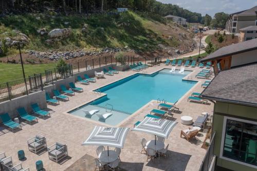 an empty swimming pool with lounge chairs and umbrellas at Near Oak Mt Amphitheatre and Pelham Civic Complex in Pelham