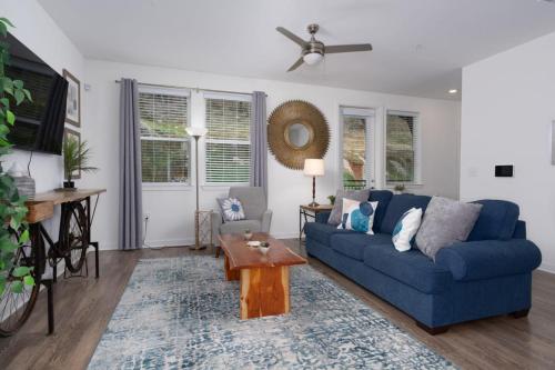 a living room with a blue couch and a table at Luxury 2BR 2 bath Townhouse w Garage Near Oak Mt in Pelham