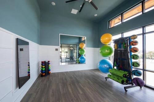 a gym with exercise equipment in a room with windows at Luxury 2BR 2 bath Townhouse w Garage Near Oak Mt in Pelham