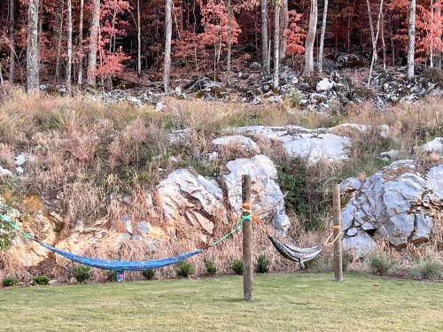 a hammock is tied to two posts in a field at Luxury 2BR 2 bath Townhouse w Garage Near Oak Mt in Pelham