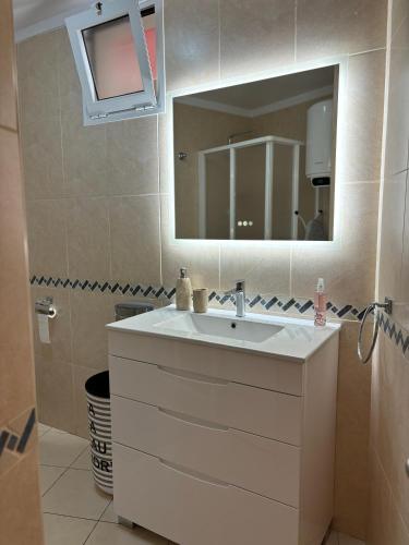 a bathroom with a sink and a mirror at Vamos Tenerife - Playa La Arena - Puerto De Santiago in Puerto de Santiago
