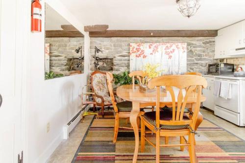 a dining room with a wooden table and chairs at Downtown by RISD Gigabite Internet OnSite Free Parking in Providence
