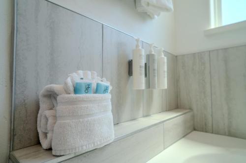 a bathroom with towels and bottles on a shelf at Marisol Condo 301 in South Padre Island