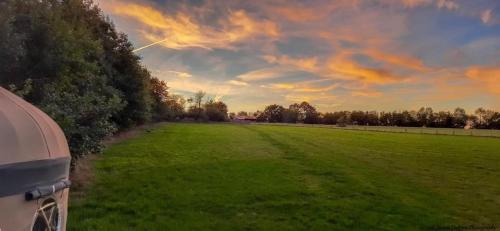 a car parked in a field with a green field at Lake View Yurts in Mere
