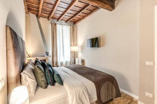 a bedroom with a bed with a wooden ceiling at Trevi Beau Boutique Hotel in Rome