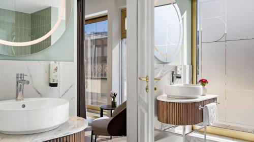 a bathroom with a sink and a mirror at Hotel Bristol Berlin in Berlin