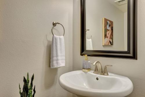 a bathroom with a sink and a mirror and a towel at The Andalusian Fusion by PaseoHomesAZ with Private Spa in Scottsdale