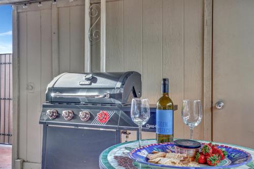 a table with a bottle of wine and two glasses at The Andalusian Fusion by PaseoHomesAZ with Private Spa in Scottsdale