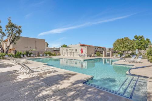 a swimming pool with lounge chairs in a courtyard at The Andalusian Fusion by PaseoHomesAZ with Private Spa in Scottsdale