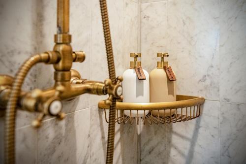 a bathroom with a faucet and two soap bottles at Fortuna Spinoza in Monnickendam