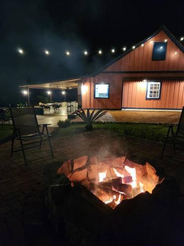 a fire pit in front of a house at night at Casa Lisova in Prudentópolis