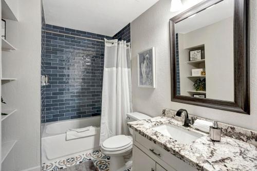 a bathroom with a sink and a toilet and a mirror at Nova Gypsy Vanner by PaseoHomesAZ with Pool & Pool in Phoenix