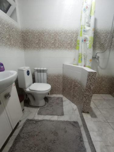 a bathroom with a toilet and a sink and a shower at VIP 5 Квартира 2ком in Oral