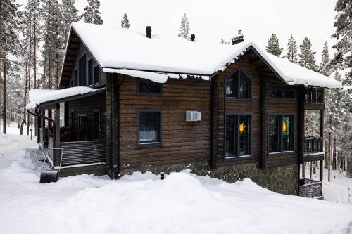 a log cabin in the snow at Grand Hideout Levi in Kittilä