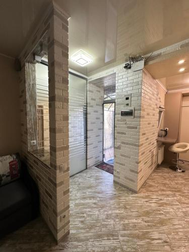 a large room with a brick wall and a door at Апартаменти Dvoryanskay in Odesa