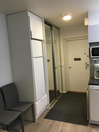 a small room with a chair and a microwave at Studio apartment B13 in the city center in Oulu