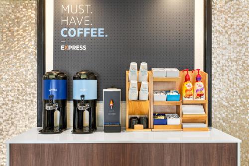 a counter with some bottles of coffee on it at Holiday Inn Express Hotel & Suites Live Oak by IHG in Live Oak