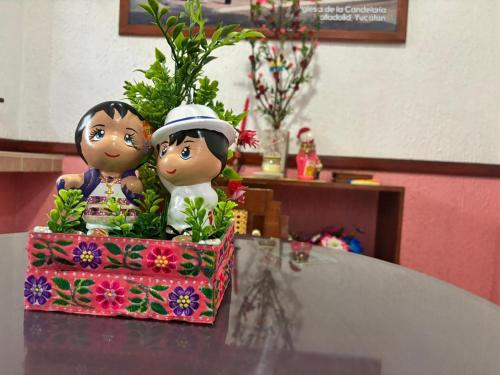 two dolls sitting on top of a table at Casa Palagui Colonial in Valladolid