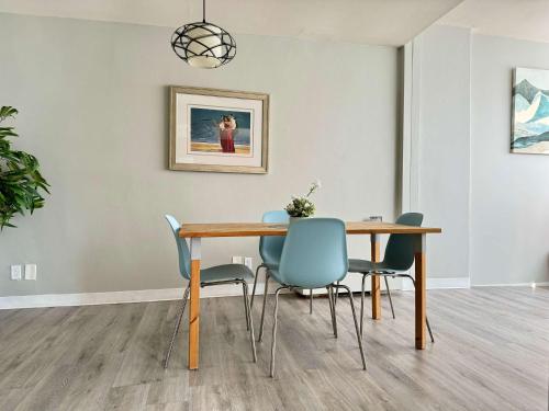 a dining room with a wooden table and chairs at Heart Downtown! City View Onsite Parking! King Bed LM807 in Atlanta