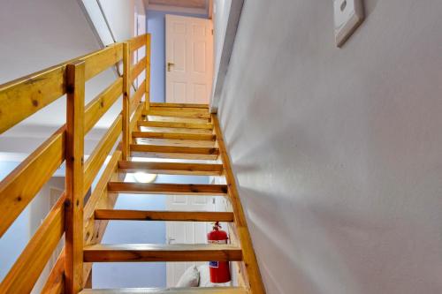 a staircase leading up to a room with a door at Anandi Guesthouse Swakopmund in Swakopmund