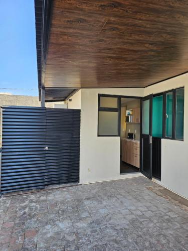 a house with a wooden ceiling and a garage at Roof Loft Cerca de Poliforum in León
