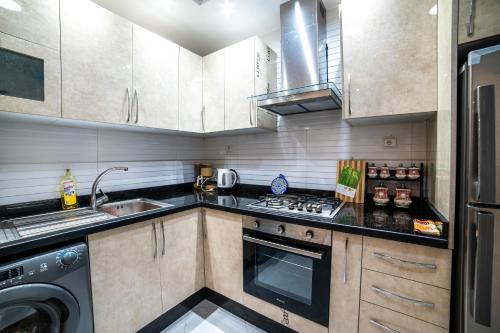 a kitchen with a sink and a stove top oven at Authentic Agadir Riad Walk to All Sights in Agadir