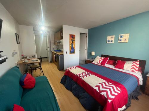 a bedroom with a bed and a couch in it at Apartment Relocation San Isidro in Santiago