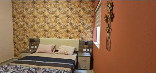 a small bedroom with a bed and a wall at Cozy Apartment 2 bdr 2 bth Terrace near Promenade J2 in Il-Gżira